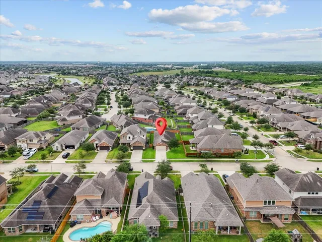 an aerial view of residential houses with outdoor space