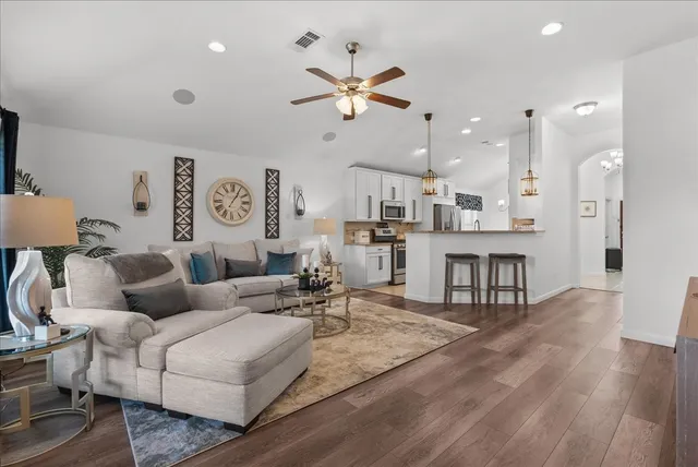a living room with furniture and kitchen view