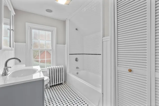 a bathroom with a bathtub and a sink