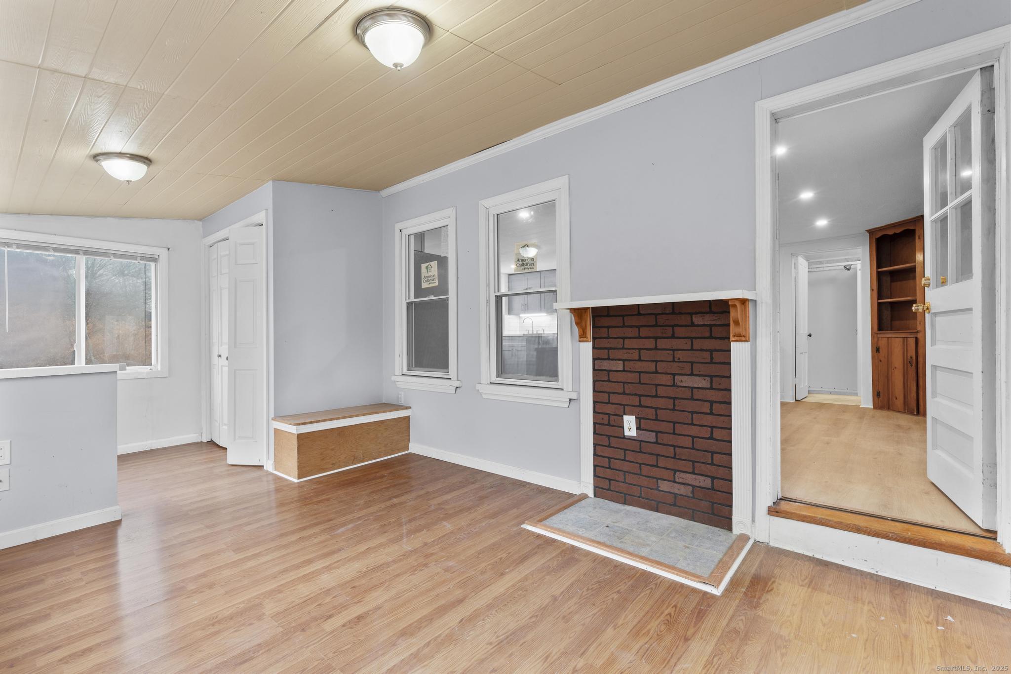 162 Scotland Road Windham, CT 06280 - Photo 16 of 31 an empty room with wooden floor and windows