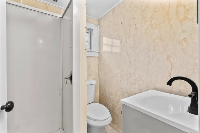 a bathroom with a sink toilet and shower