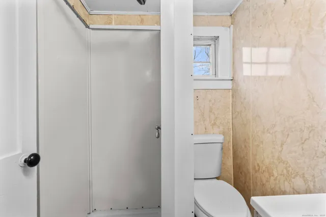 a white toilet sitting next to a bathroom sink