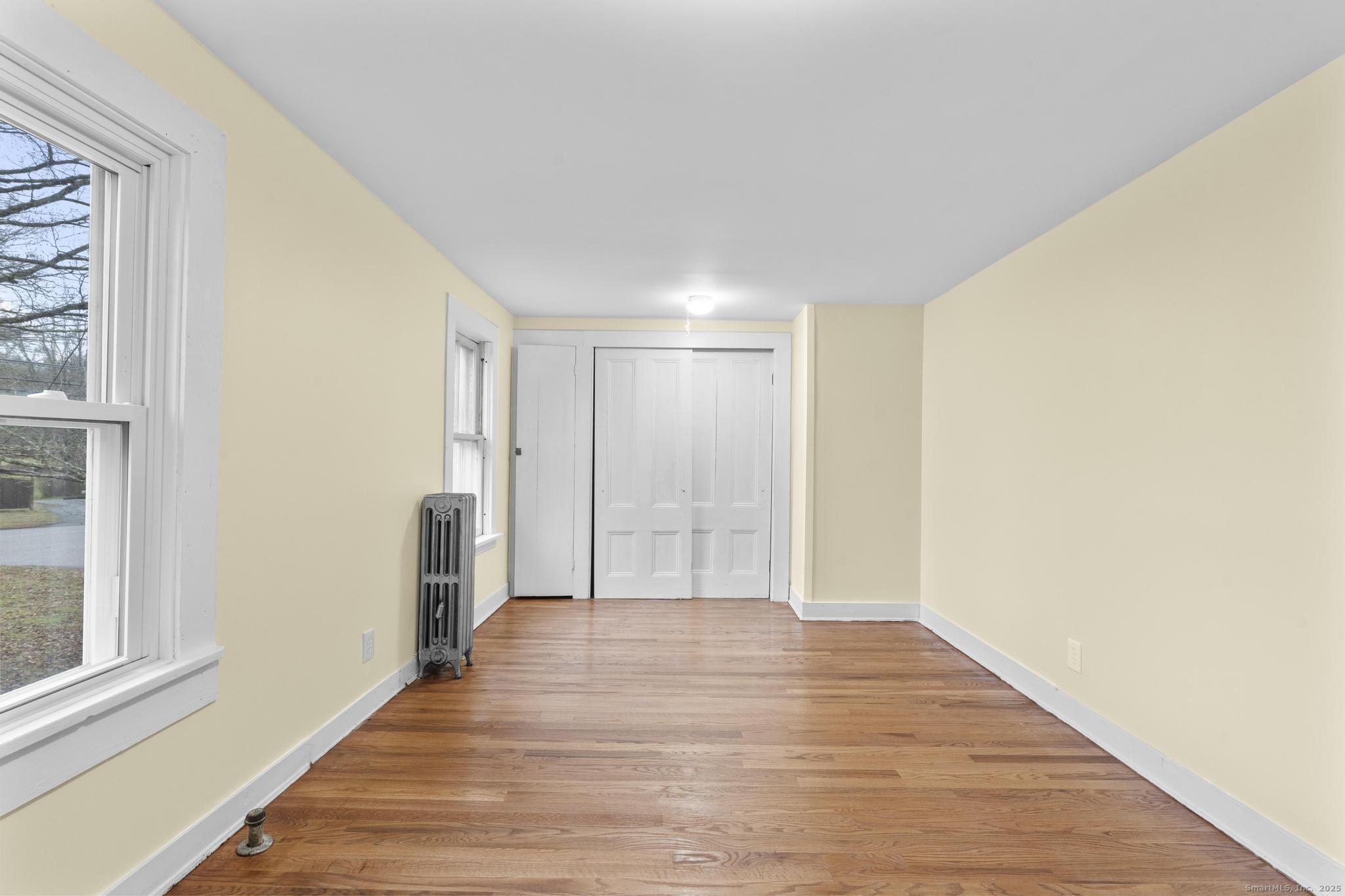 162 Scotland Road Windham, CT 06280 - Photo 20 of 31 a view of an empty room with wooden floor and a window