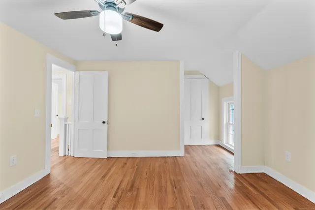 a view of an empty room with wooden floor