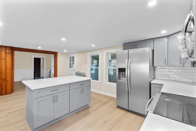 a kitchen with stainless steel appliances a refrigerator sink and cabinets
