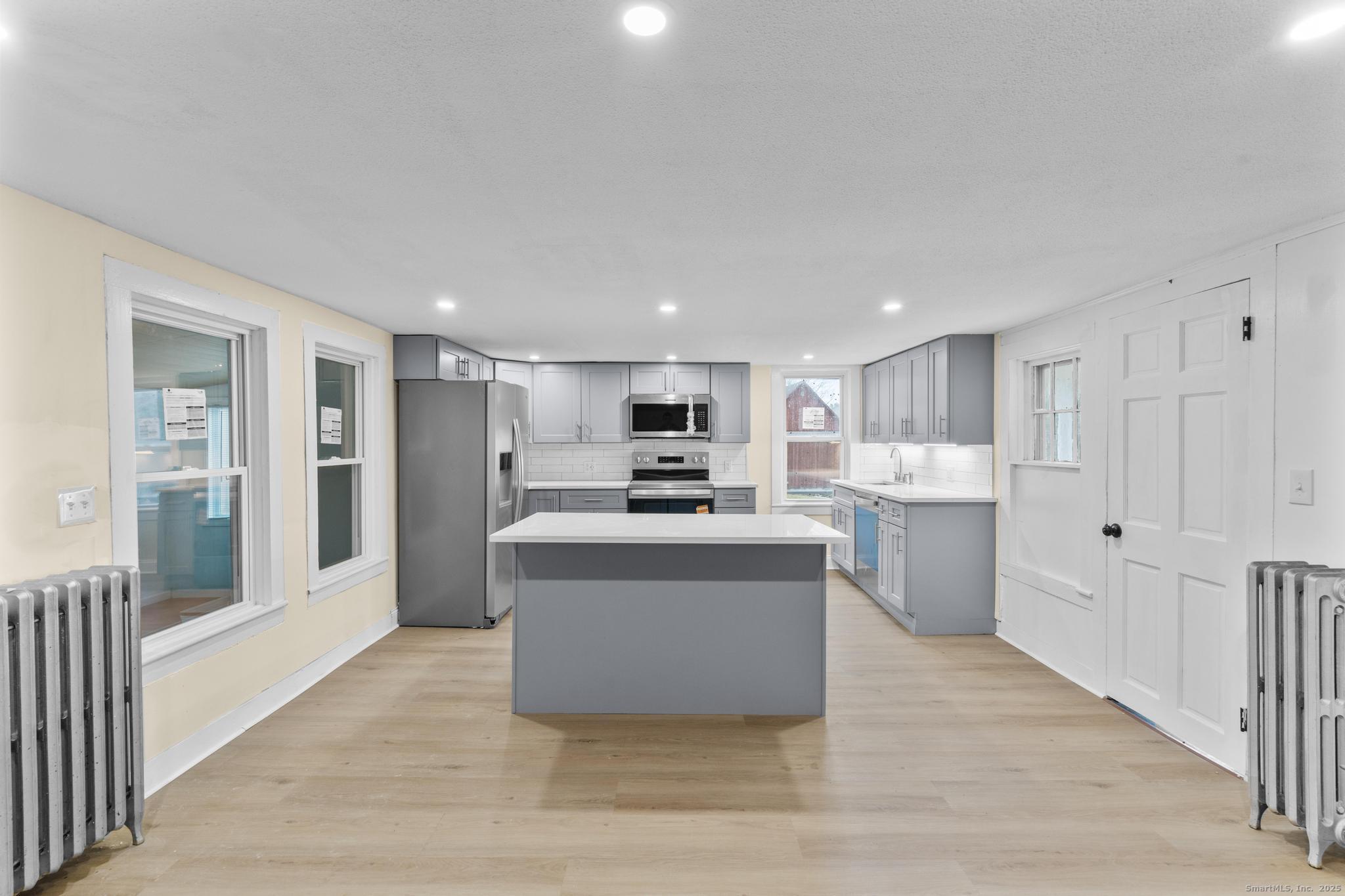 162 Scotland Road Windham, CT 06280 - Photo 5 of 31 a living room with stainless steel appliances kitchen island granite countertop a stove and a refrigerator