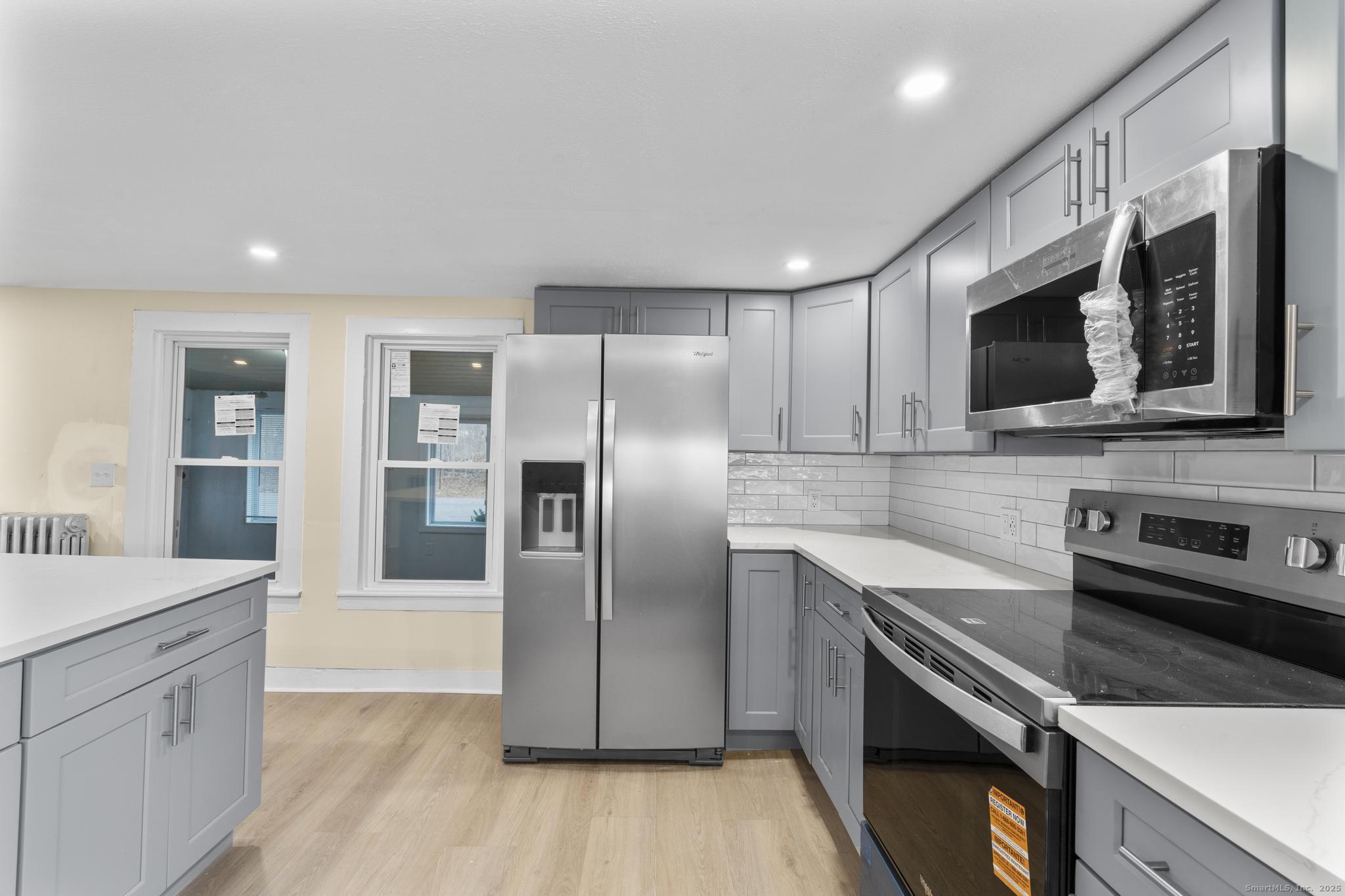 162 Scotland Road Windham, CT 06280 - Photo 7 of 31 a kitchen with stainless steel appliances granite countertop a refrigerator a sink a stove a microwave and wooden floors