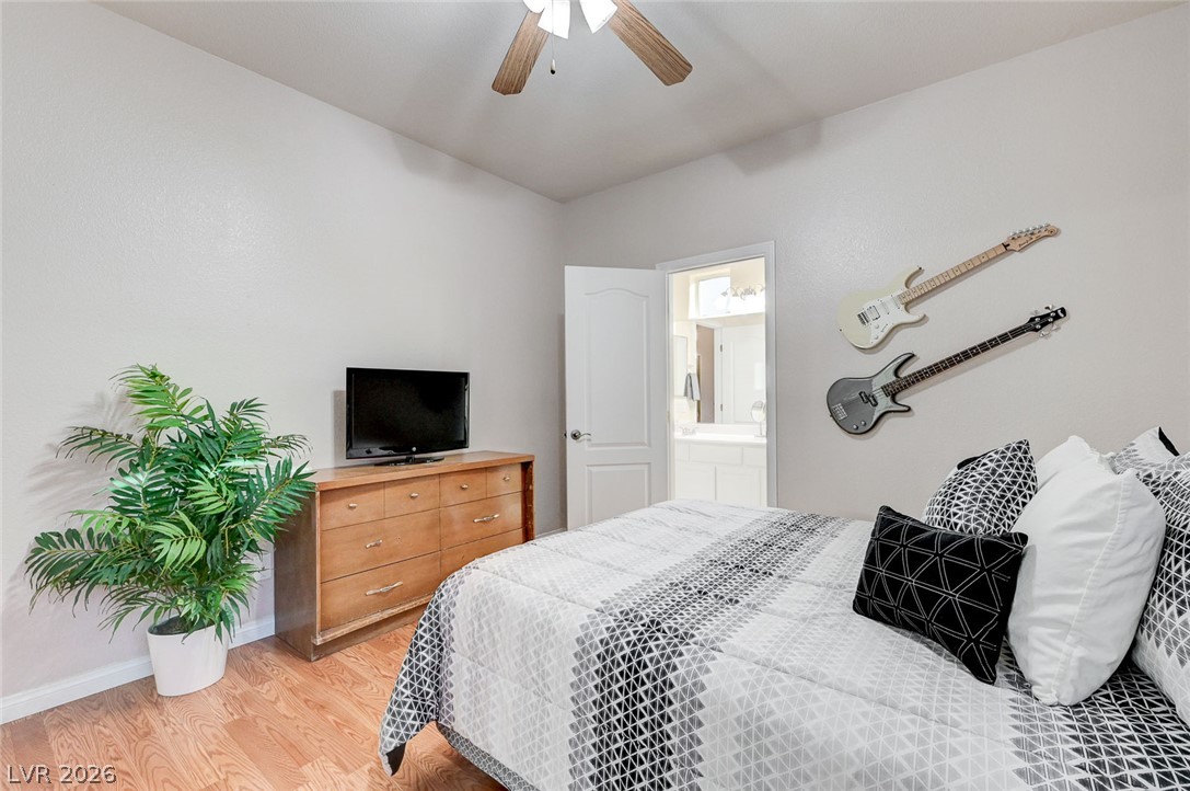 1604 Cattle Ranch Place Henderson, NV 89002 - Photo 50 of 99 Hardwood flooring and a ceiling fan create a comfortable and stylish bedroom retreat.