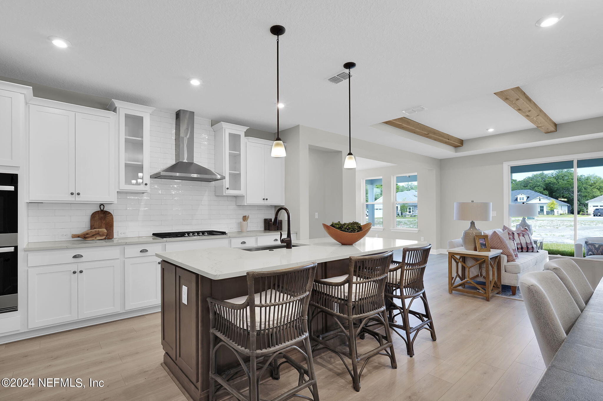 117 Greylock Lane St. Augustine, FL 32092 - Photo 18 of 48 a kitchen with stainless steel appliances kitchen island granite countertop a sink a stove a dining table and chairs