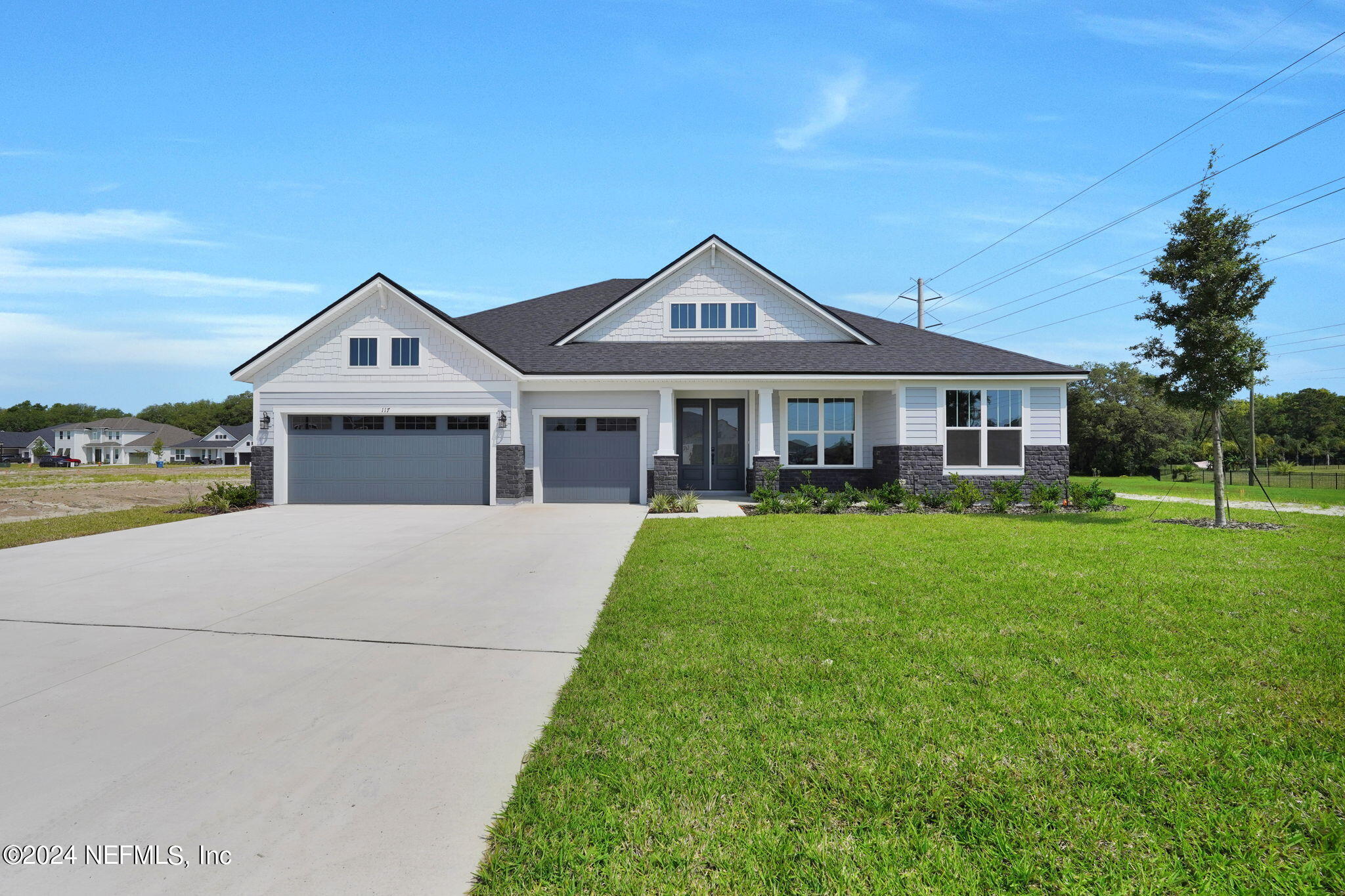 117 Greylock Lane St. Augustine, FL 32092 - Photo 2 of 48 a front view of a house with a yard and garage