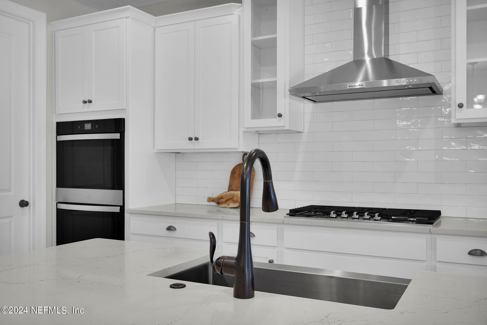 117 Greylock Lane St. Augustine, FL 32092 - Photo 21 of 48 a kitchen with granite countertop white cabinets and black appliances