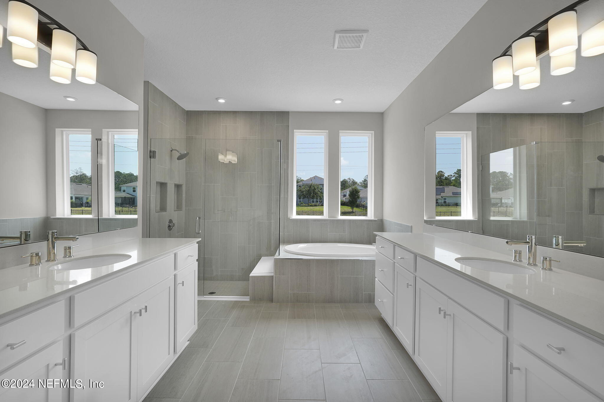 117 Greylock Lane St. Augustine, FL 32092 - Photo 32 of 48 a spacious bathroom with a double vanity sink a large mirror and a bathtub