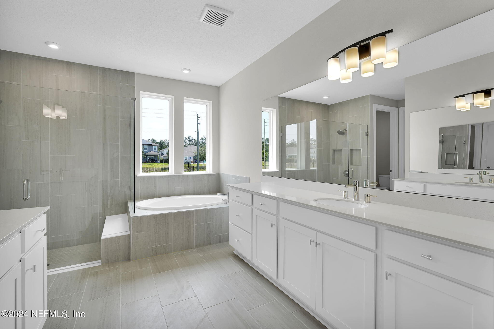 117 Greylock Lane St. Augustine, FL 32092 - Photo 33 of 48 a spacious bathroom with a double vanity sink a large mirror and a bathtub