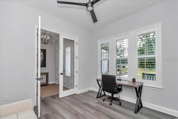 a view of a workspace with furniture and a window
