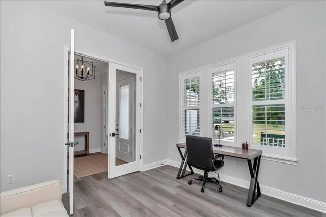 a view of a workspace with furniture and a window
