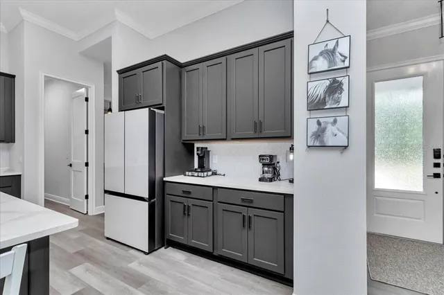 a kitchen with stainless steel appliances a refrigerator and cabinets