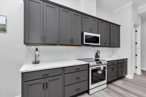 a kitchen with stainless steel appliances granite countertop a sink a stove a microwave and cabinets