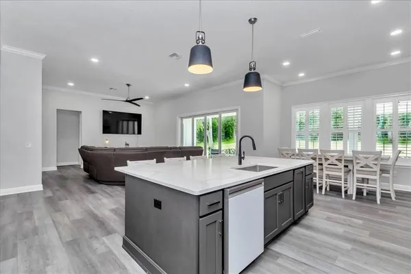 a kitchen with lots of counter space a sink appliances and a counter top space