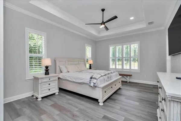 a bedroom with a large bed and a window