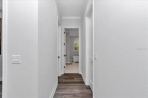 a view of a hallway with a wooden door