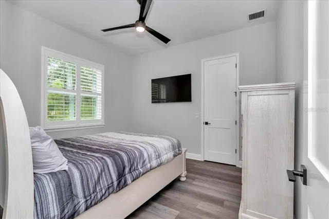 a bedroom with a bed and a flat screen tv