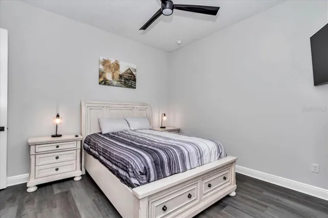 a bedroom with a bed and a tv