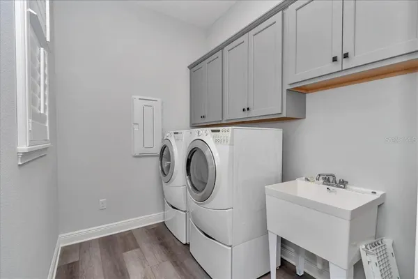 a utility room with sink dryer and washer