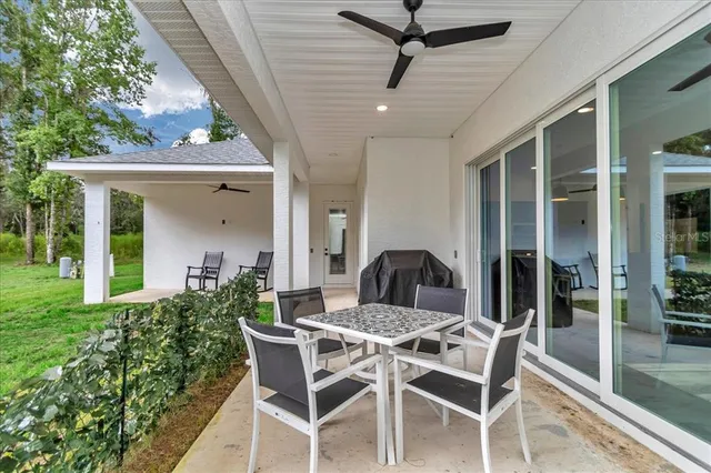 a view of a house with backyard and porch