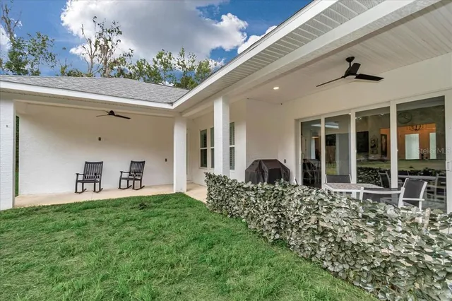 a view of a house with backyard and porch