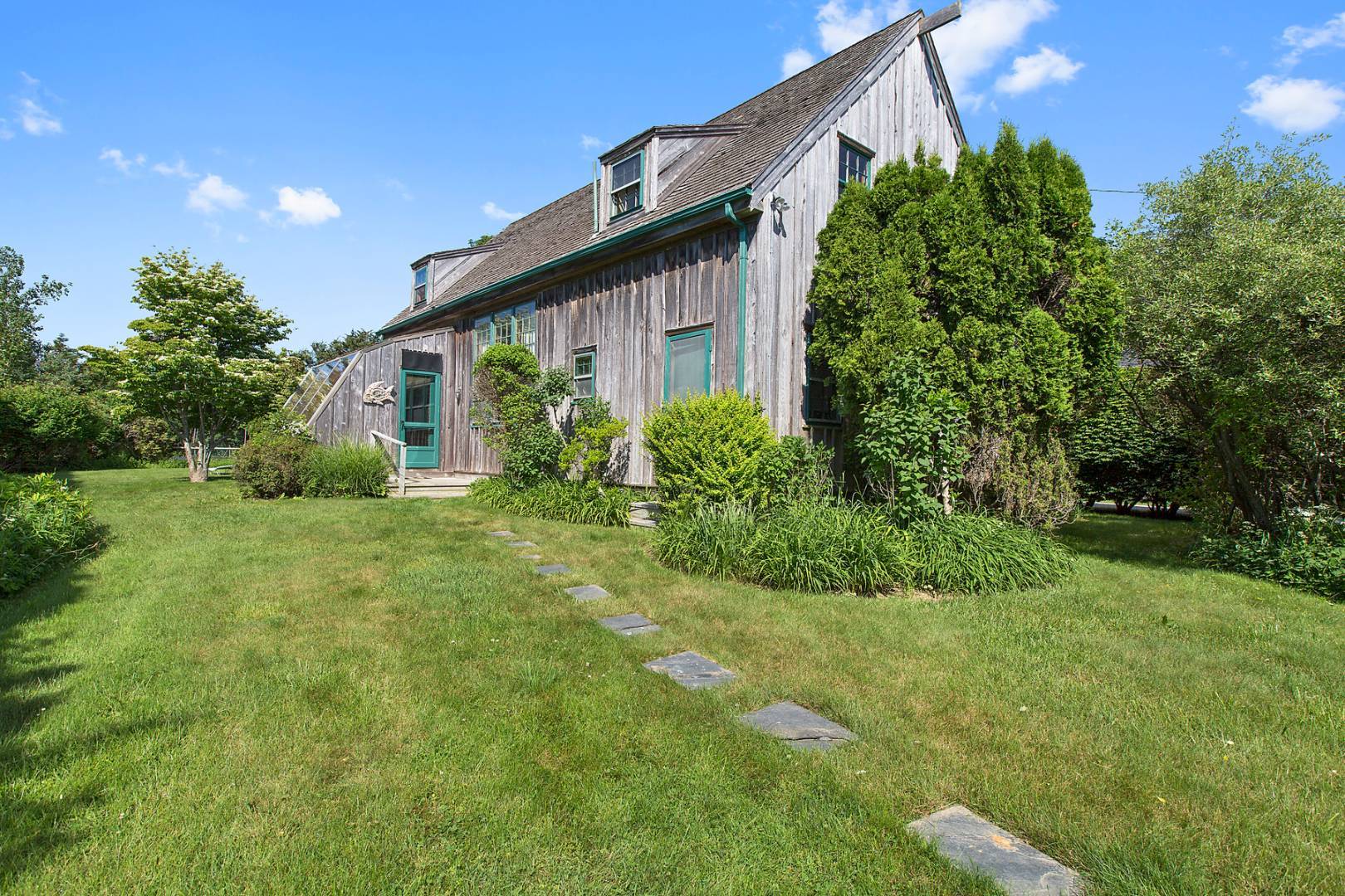 172 Town Line Road Sagaponack, NY 11962 - Photo 4 of 5 a front view of a house with garden