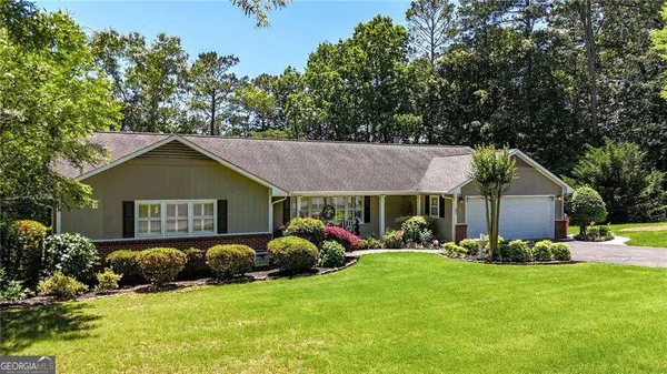 a front view of house with yard and green space