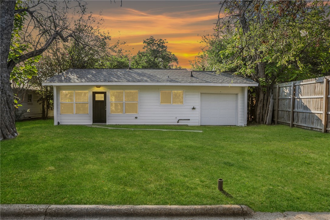 a front view of house with yard and green space