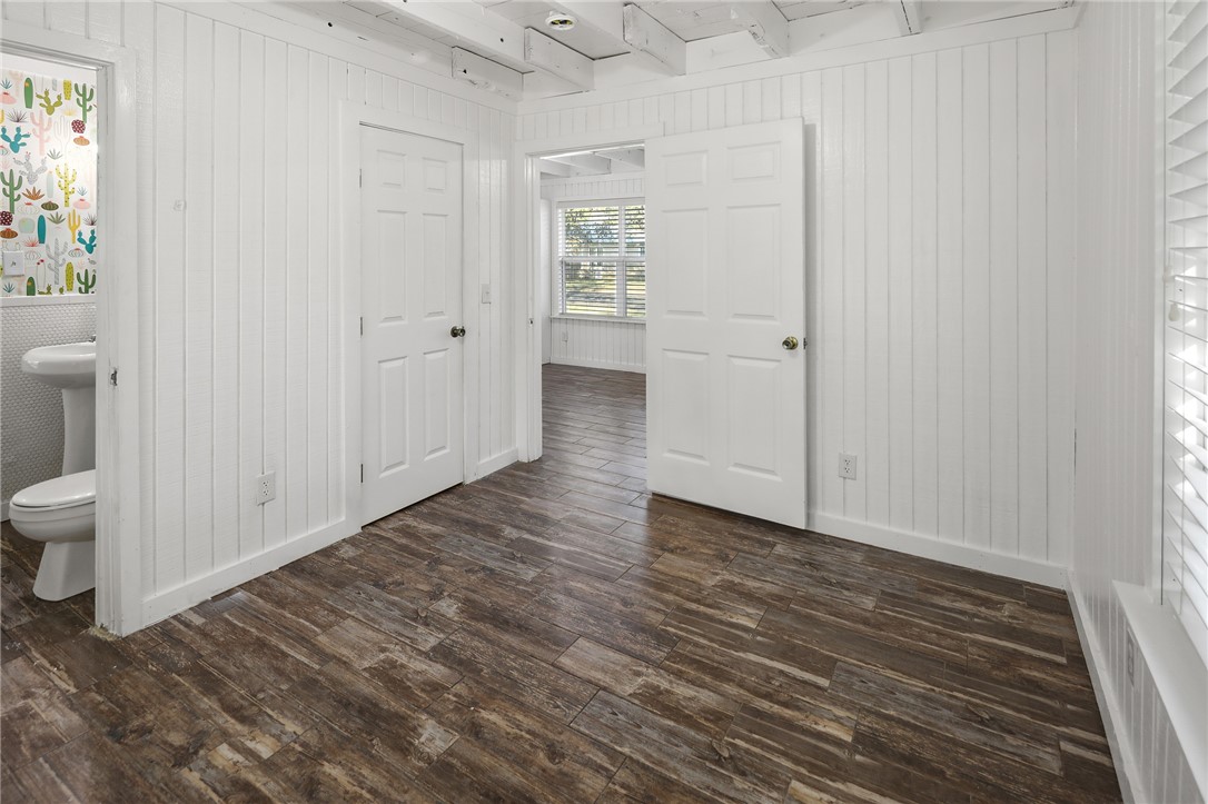 105 South Brown Street Bryan, TX 77802 - Photo 12 of 20 a view of an empty room and bathroom with wooden floor