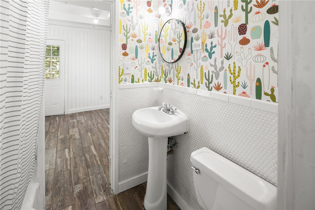 105 South Brown Street Bryan, TX 77802 - Photo 13 of 20 a bathroom with a sink a toilet and a mirror