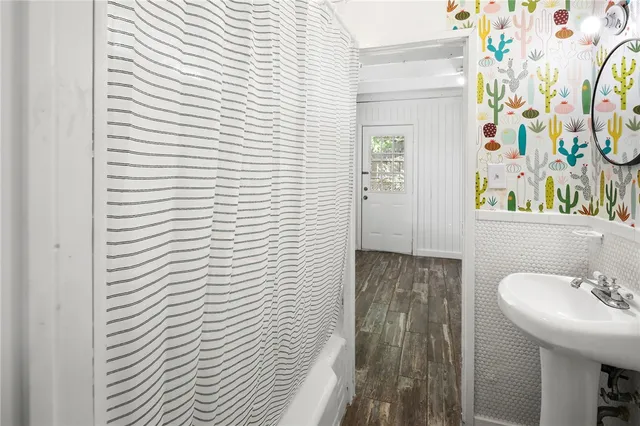 a bathroom with a sink and mirror with toilet