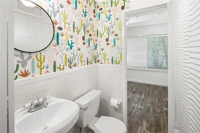 a white toilet sitting next to a bathroom sink