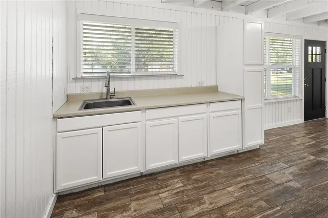a kitchen with a sink and cabinets