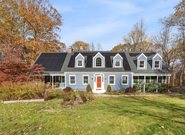 a front view of a house with a garden