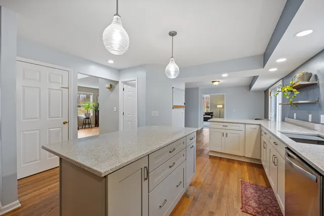 a large kitchen with cabinets and wooden floor