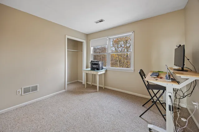 a workspace with furniture and window