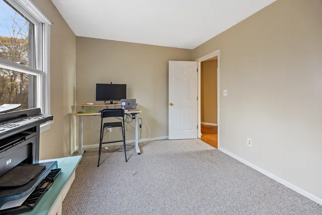 a view of a livingroom with furniture and a window