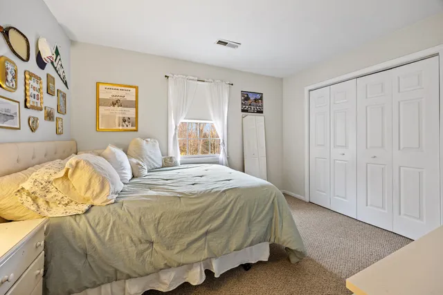 a spacious bedroom with a bed and a window