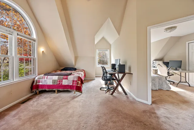 a bedroom with furniture and a large window