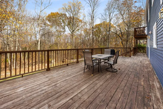 a view of a deck with table and chairs and wooden floor