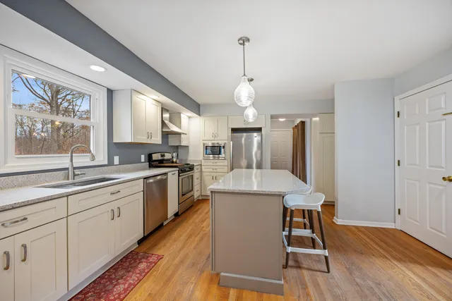 a kitchen with sink cabinets and wooden floor