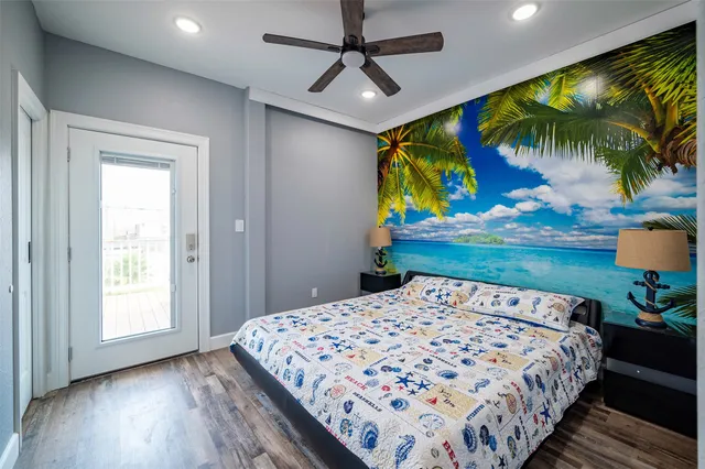 a bedroom with a bed and a painting on the wall