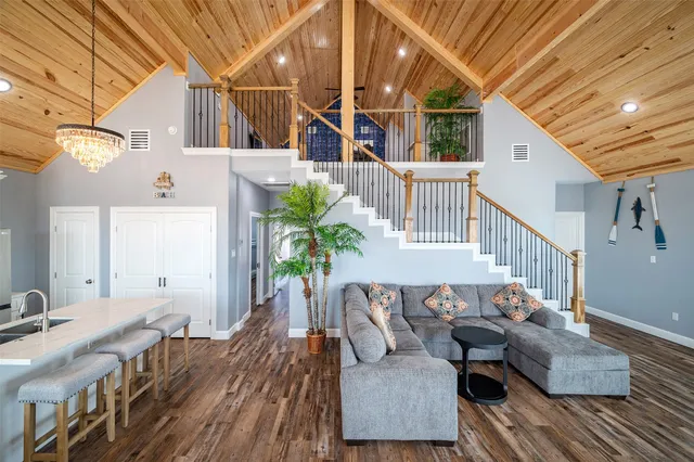 a view of a house with wooden deck and furniture