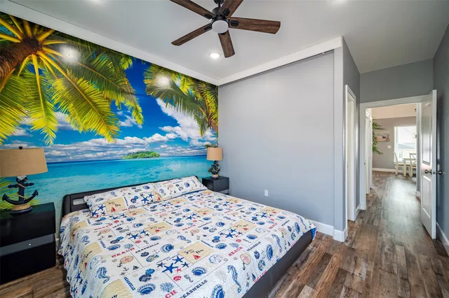 a bedroom with a bed and a painting on the wall