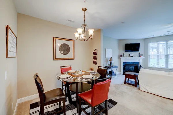 a dining room with furniture a livingroom and chandelier