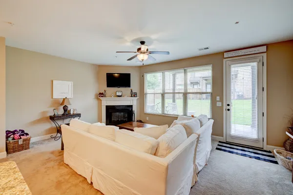 a living room with furniture a fireplace and a flat screen tv